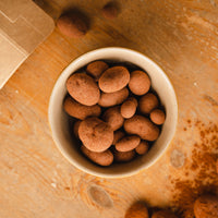Cocoa beans coated with milk chocolate